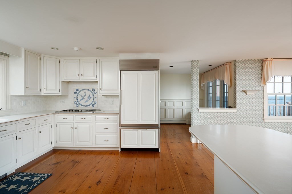 475 Jerusalem Road Cohasset, MA 02025 - Photo 7 of 41 a kitchen with granite countertop white cabinets and wooden floors