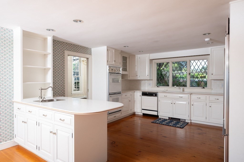 475 Jerusalem Road Cohasset, MA 02025 - Photo 8 of 41 a room with white cabinets and wooden floors