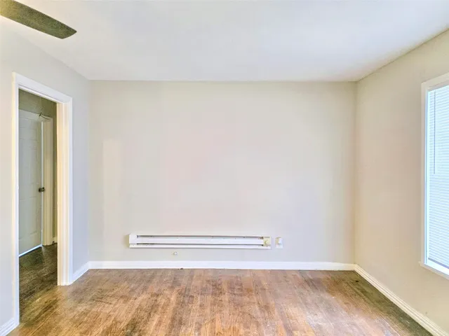 a view of a room with wooden floor