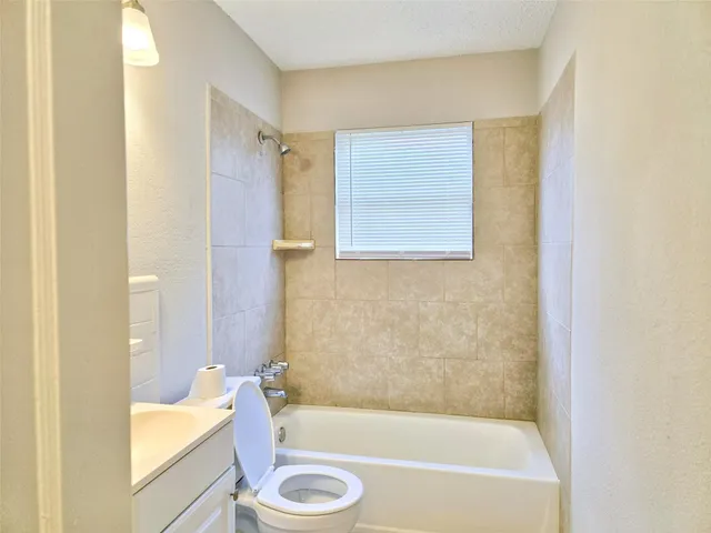 a bathroom with a tub toilet and sink