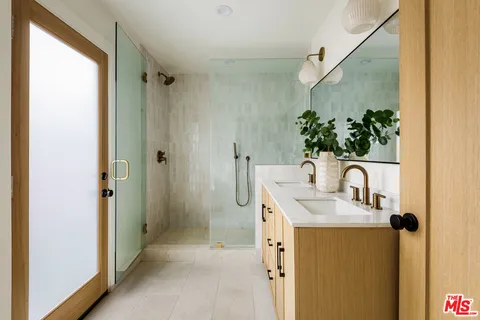 a bathroom with a sink a mirror and shower