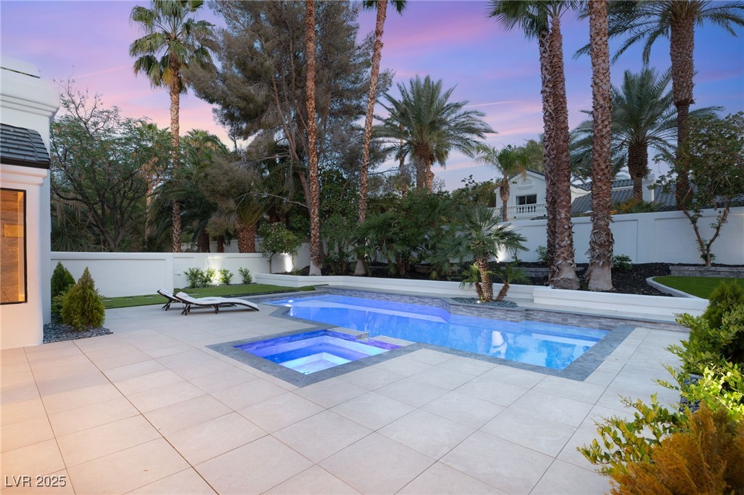 2316 Prometheus Court Henderson, NV 89074 - Photo 66 of 92 Pool at dusk featuring a patio area, a fenced backyard, an in ground hot tub, and a fenced in pool