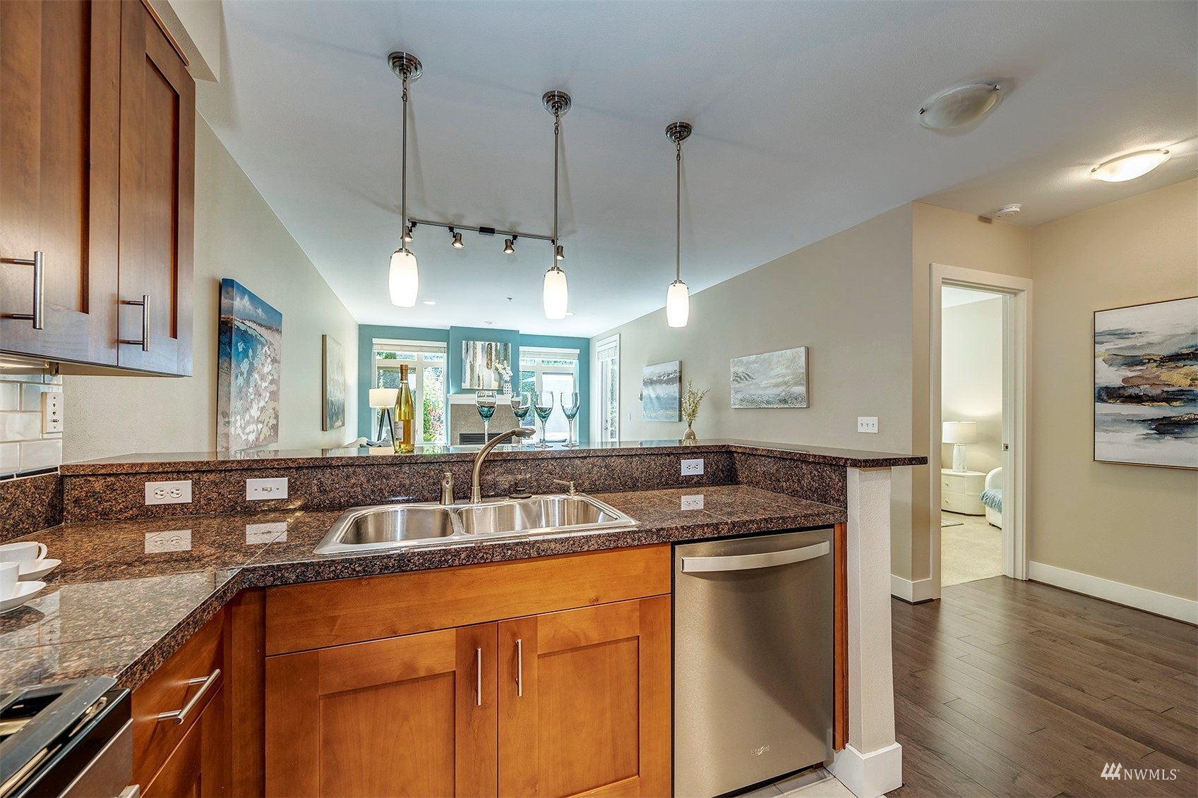 51 Pine Street, Unit 202 Edmonds, WA 98020 - Photo 11 of 30 a kitchen with stainless steel appliances granite countertop a sink a stove and a wooden floors