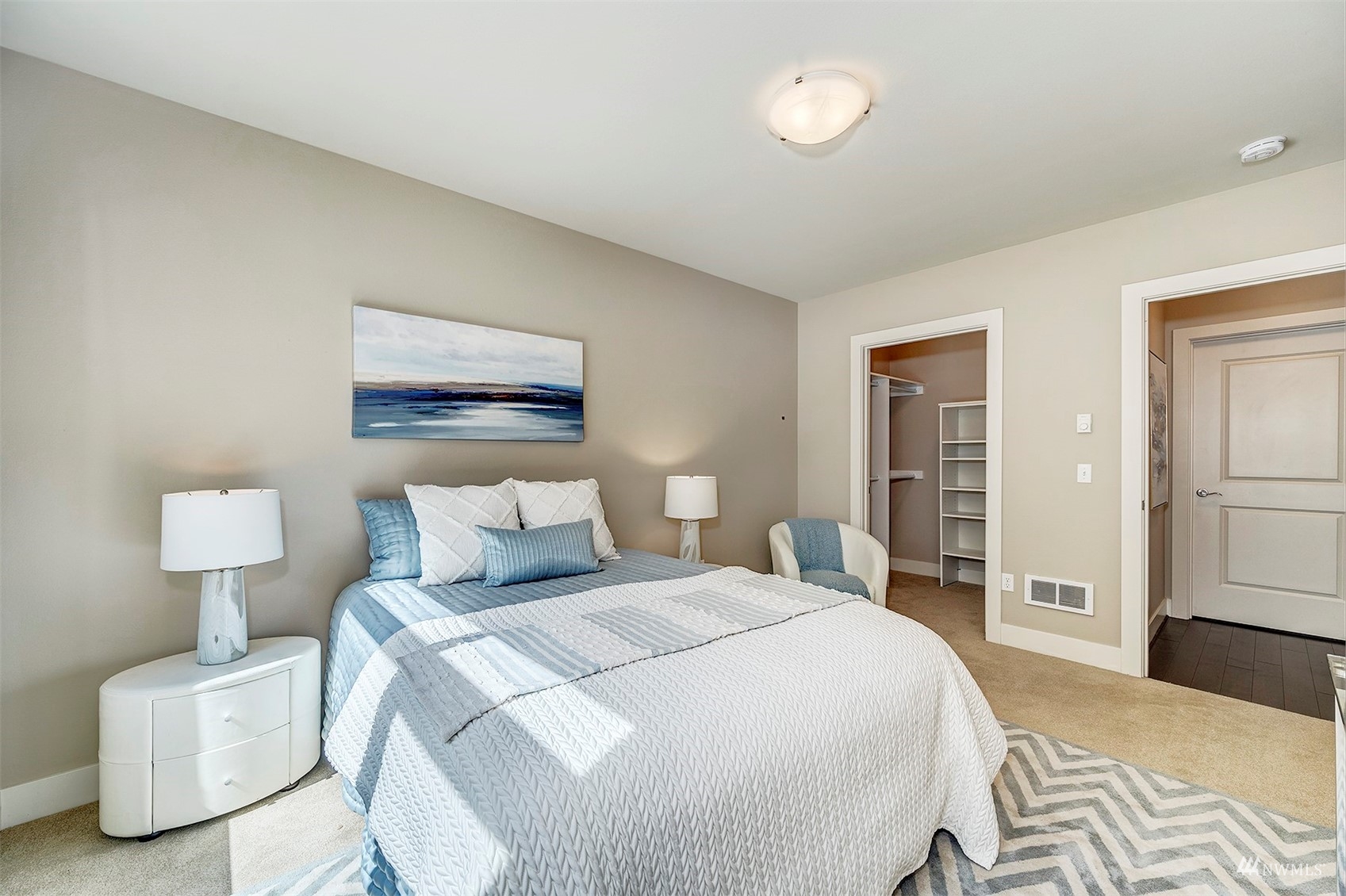 51 Pine Street, Unit 202 Edmonds, WA 98020 - Photo 15 of 30 a bedroom with a bed and a lamp