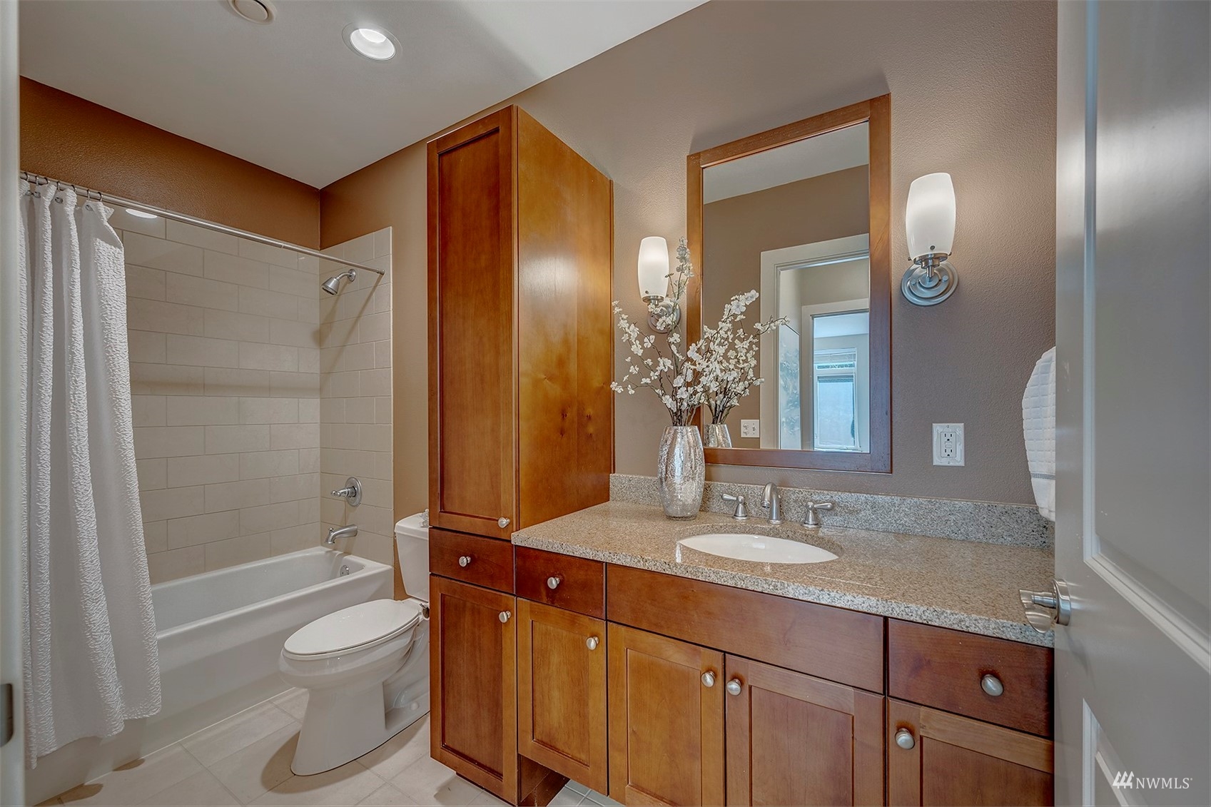 51 Pine Street, Unit 202 Edmonds, WA 98020 - Photo 16 of 30 a bathroom with a granite countertop sink toilet and shower