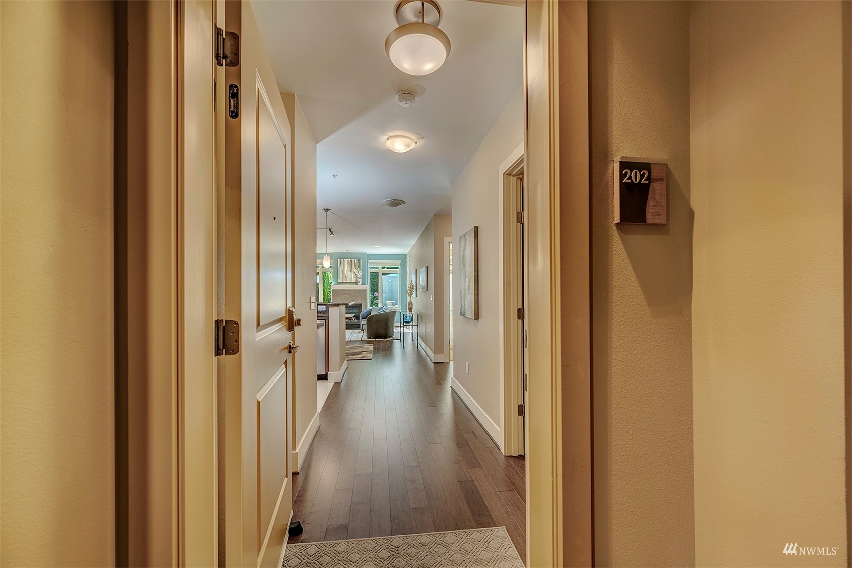 51 Pine Street, Unit 202 Edmonds, WA 98020 - Photo 5 of 30 a view of a hallway with wooden floor and a bathroom