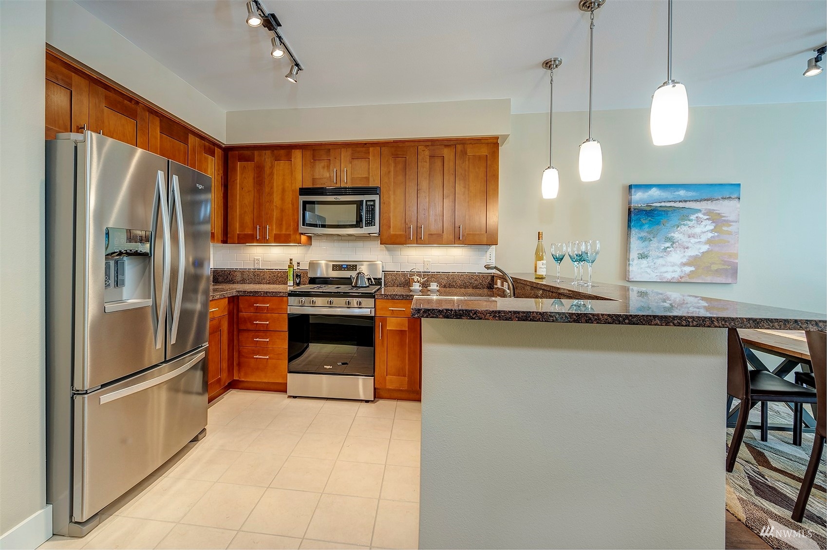 51 Pine Street, Unit 202 Edmonds, WA 98020 - Photo 10 of 30 a kitchen with stainless steel appliances granite countertop a refrigerator a stove a sink a oven and a refrigerator
