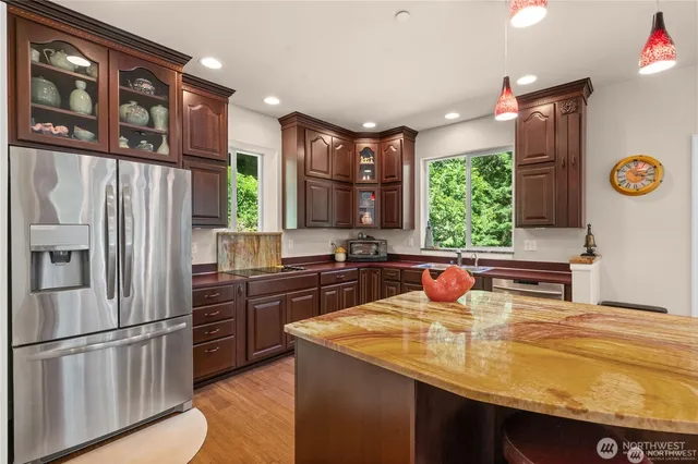 a kitchen with stainless steel appliances a sink stove and refrigerator