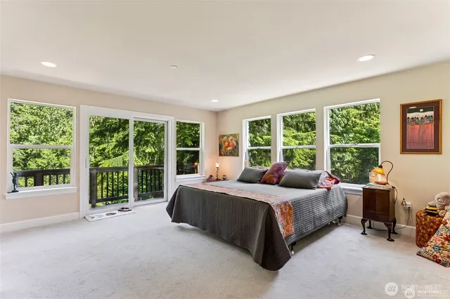 a bedroom with a bed and a large window