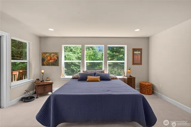 a bed sitting in a room next to a window