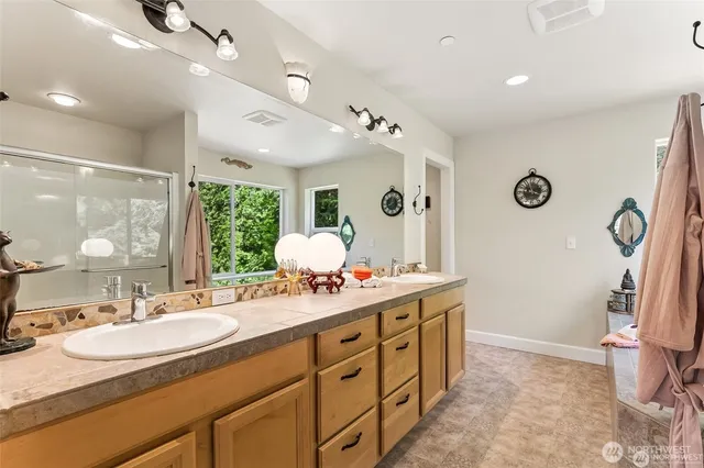 a bathroom with a sink double vanity and a mirror