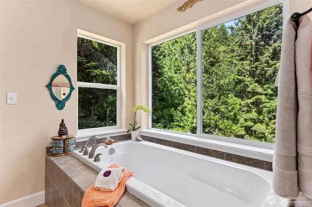 a bath tub sitting in a bathroom next to a window