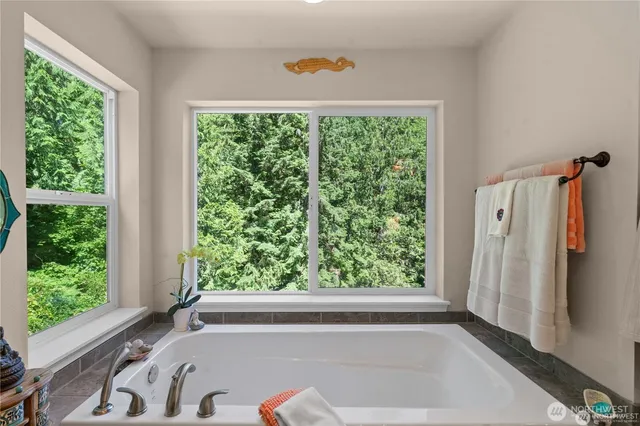 a bathroom with a bathtub and a shower