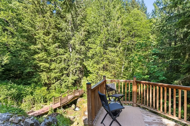 a balcony with wooden floor and yard in back