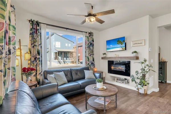 a living room with furniture a fireplace and a flat screen tv