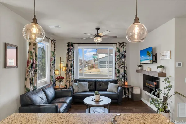 a living room with furniture a fireplace and a chandelier