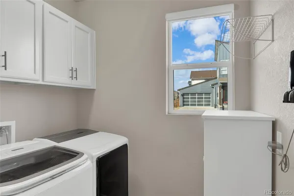 a view of storage and utility room with washer and dryer