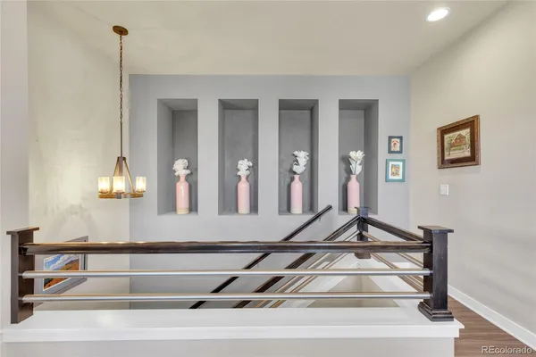 a view of staircase with white walls and railing