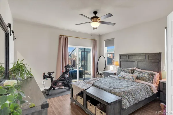 a bedroom with a bed a chandelier and dresser