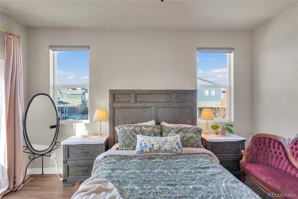 a bedroom with a bed a couch and dresser