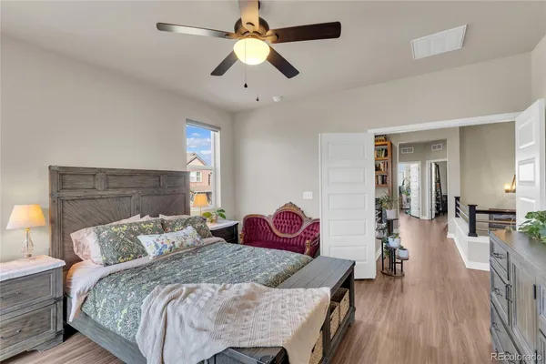 a bedroom with a bed and wooden floor