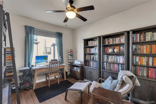 a living room with furniture and a book shelf