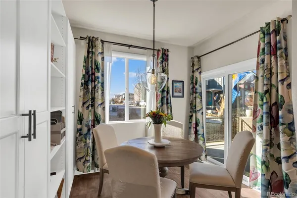 a view of a dining room with furniture window and wooden floor