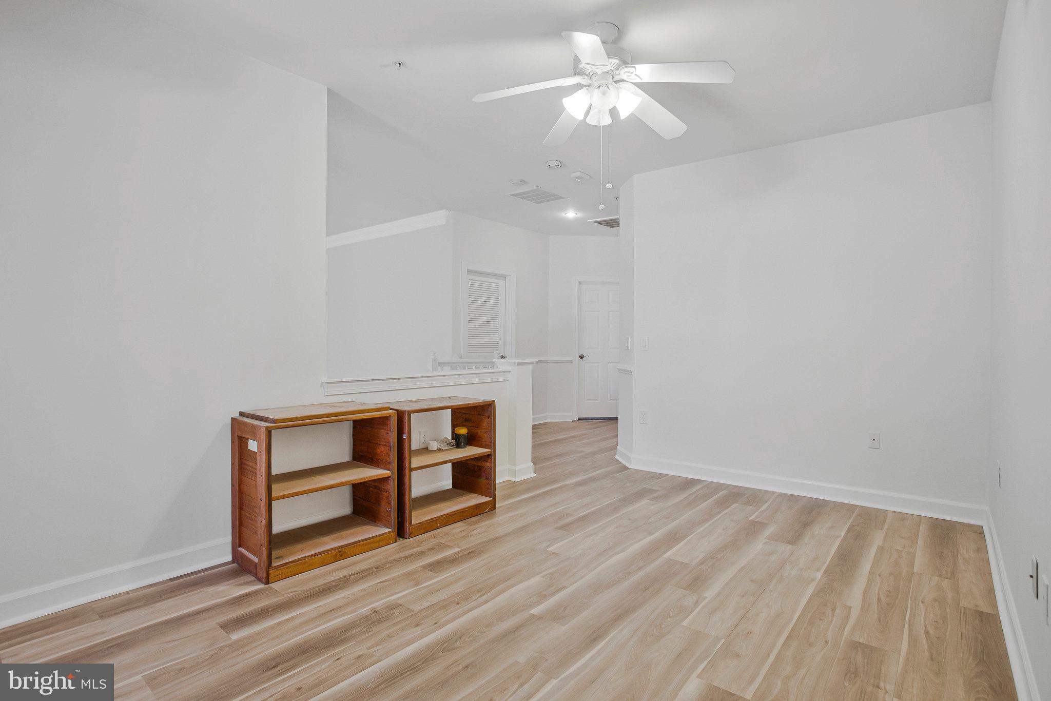322 Hamlet Circle Edgewater, MD 21037 - Photo 18 of 21 an empty room with wooden floor and ceiling fan