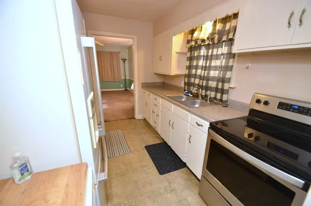 a kitchen with sink and refrigerator