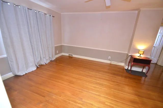 a view of a room with wooden floor and chair