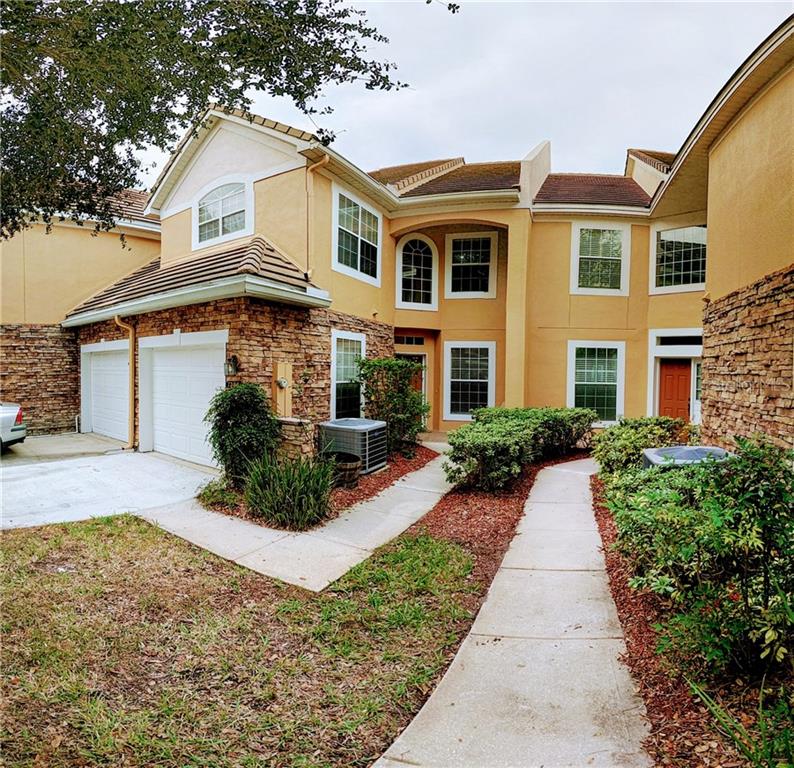 7306 Cypress Grove Road, Unit 64 Orlando, FL 32819 - Photo 1 of 1 front view of a house with a yard