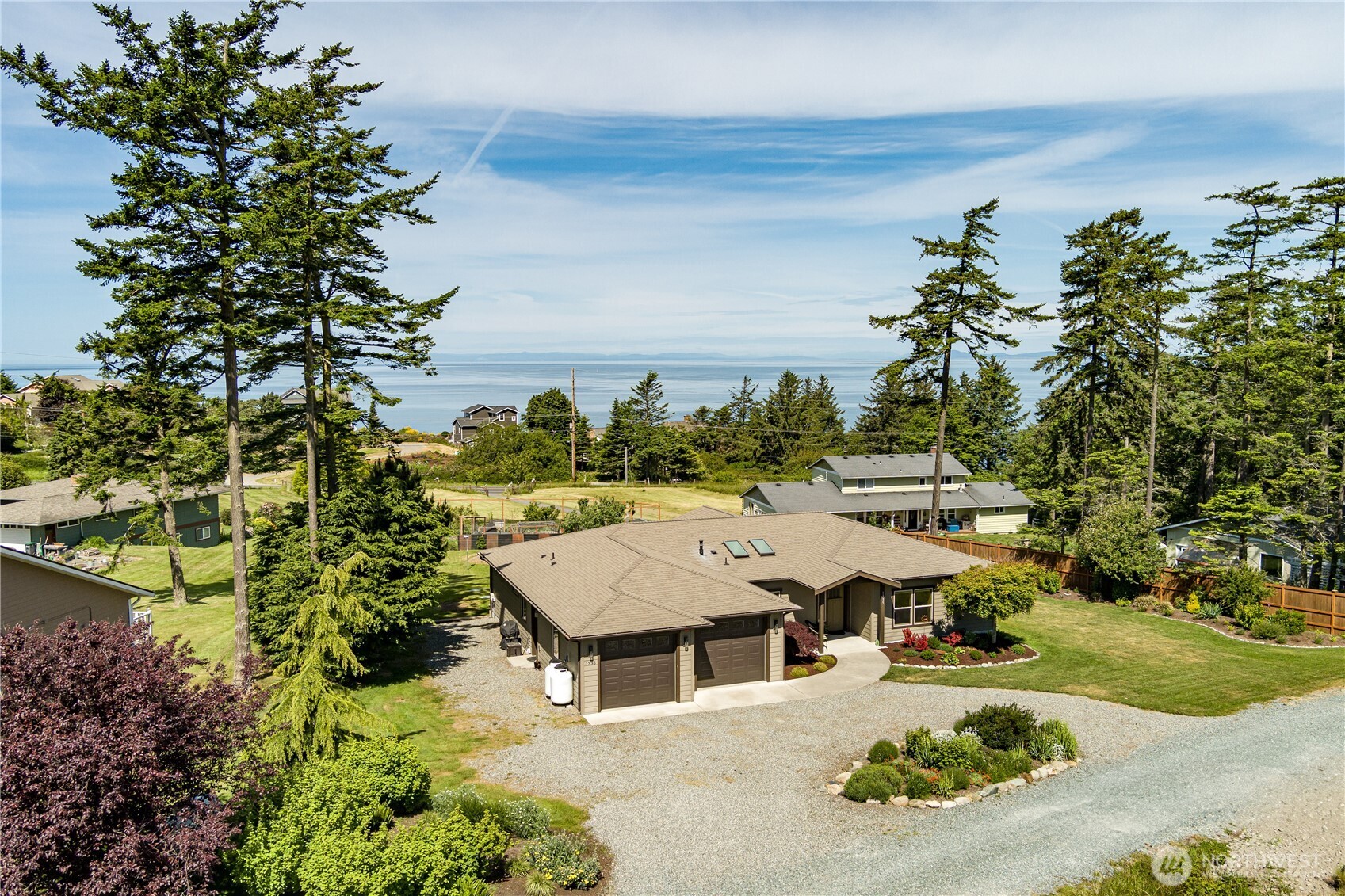 1335 Crestline Terrace Oak Harbor, WA 98277 - Photo 36 of 39 an aerial view of a house with swimming pool and large trees