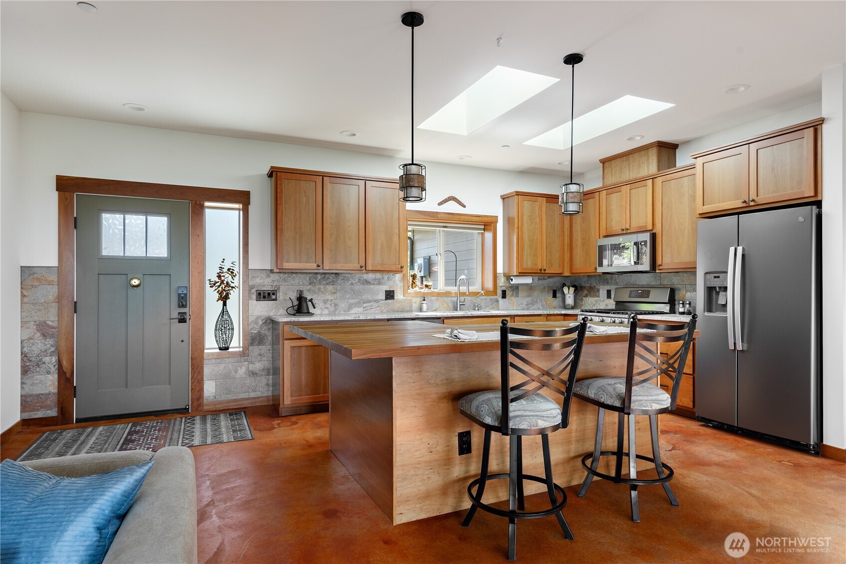1335 Crestline Terrace Oak Harbor, WA 98277 - Photo 4 of 39 a kitchen with stainless steel appliances granite countertop a refrigerator a stove a sink dishwasher a dining table and chairs with wooden floor