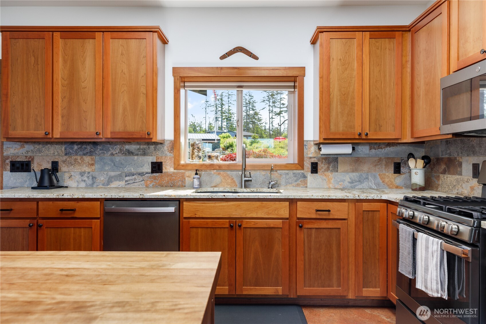 1335 Crestline Terrace Oak Harbor, WA 98277 - Photo 9 of 39 a kitchen with stainless steel appliances granite countertop wooden cabinets a sink and a window