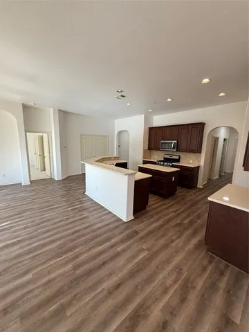 a view of kitchen with wooden floor and electronic appliances