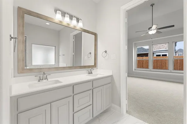 a bathroom with a double vanity sink mirror and