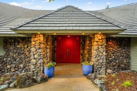 a outdoor view of a patio with plants and chairs