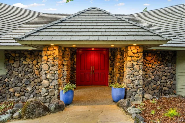 a outdoor view of a patio with plants and chairs