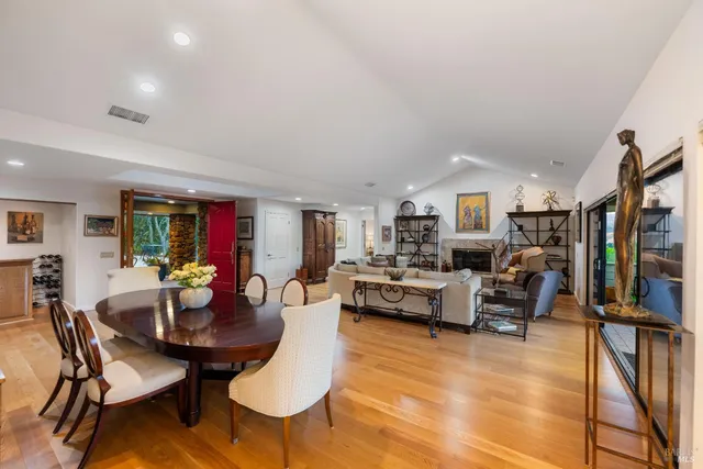 a living room with fireplace furniture and a view of kitchen