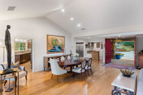 a dining room with furniture a rug and wooden floor