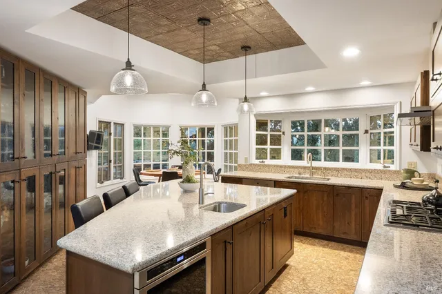 a large kitchen with kitchen island a sink a counter space and stainless steel appliances