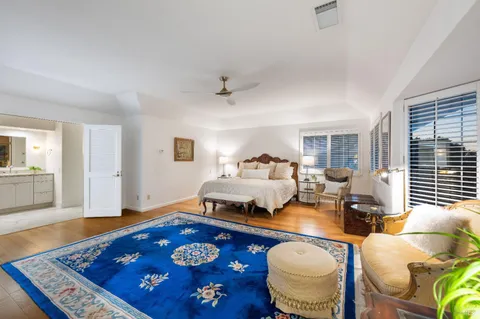 a bedroom with furniture and a rug