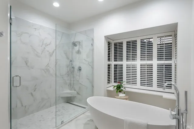 a bathroom with a bathtub and shower