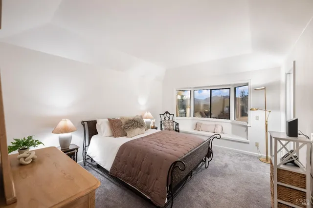 a spacious bedroom with two beds and large windows