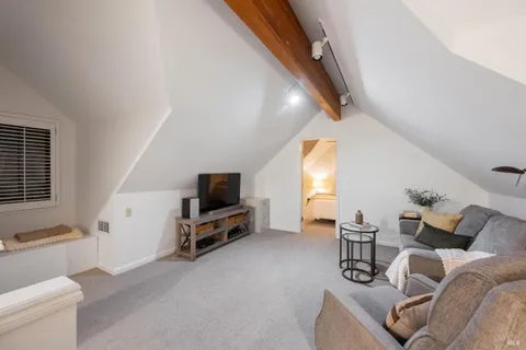 a living room with furniture a window and a flat screen tv