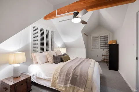 a bedroom with a bed and a night stand