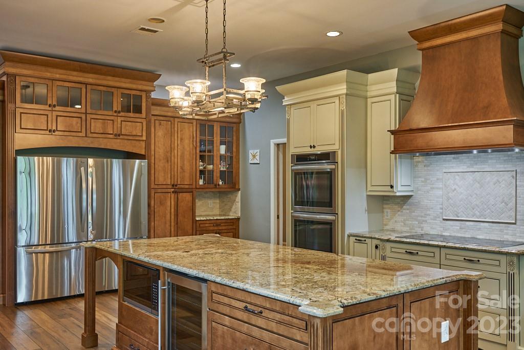 290 Stable Gate Drive Campobello, SC 29322 - Photo 19 of 39 a kitchen with stainless steel appliances granite countertop a refrigerator oven a sink dishwasher and white cabinets