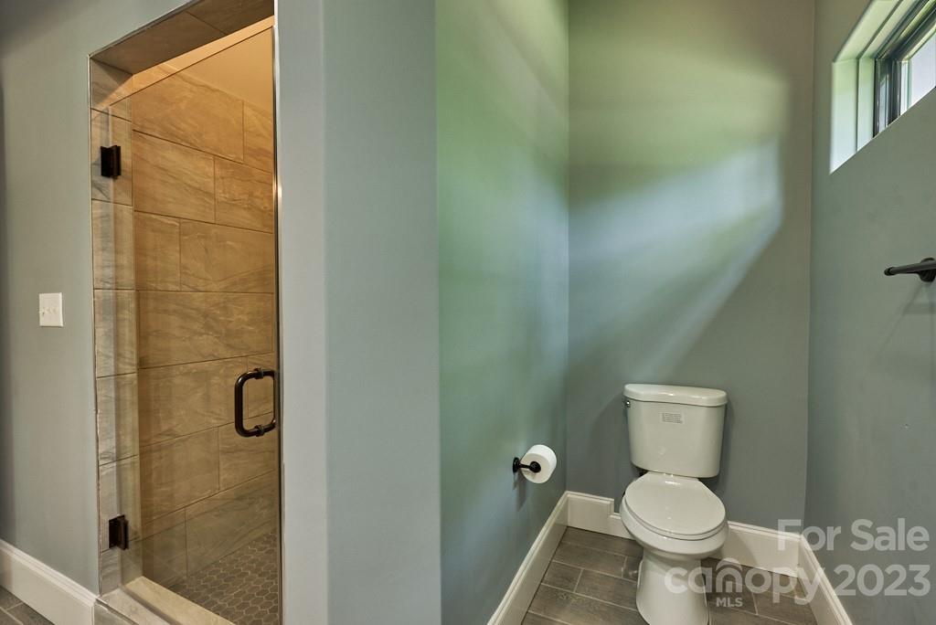 290 Stable Gate Drive Campobello, SC 29322 - Photo 32 of 39 a white toilet sitting next to a shower and a sink