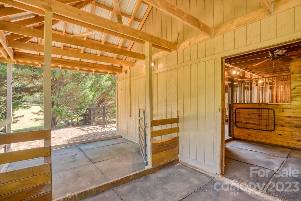 290 Stable Gate Drive Campobello, SC 29322 - Photo 36 of 39 a view of a porch with a wooden floor and a chair
