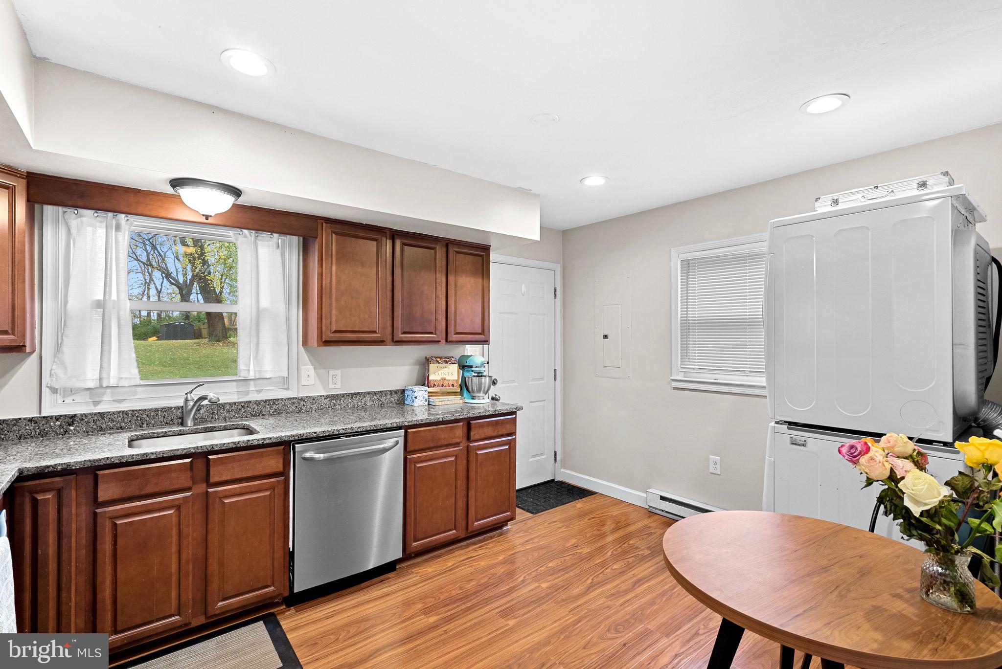 219 Josephine Street Berryville, VA 22611 - Photo 11 of 26 a kitchen with stainless steel appliances granite countertop wooden cabinets a sink stove and refrigerator